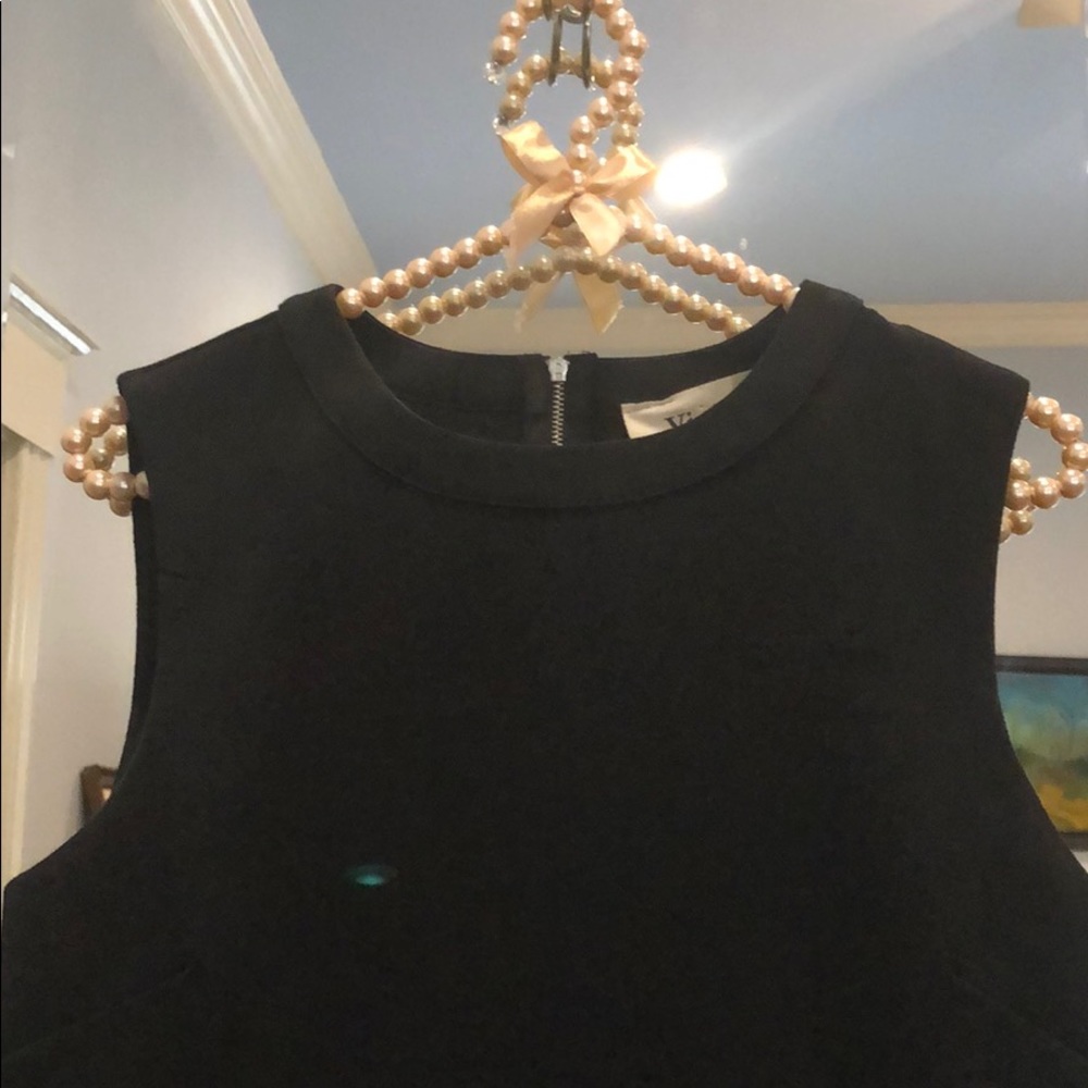 Black blouse with feather bottom trim